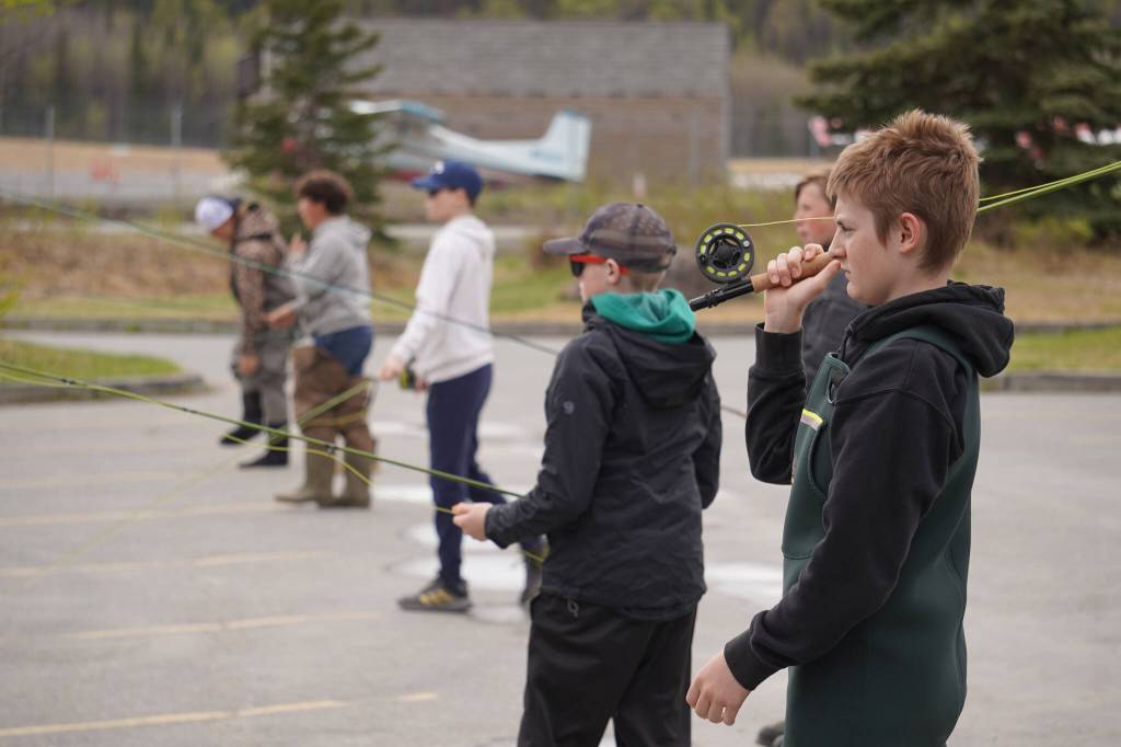 Middle schoolers practice fly casting in the parking lot of the Donald E. Gilman Kenai River Center in Soldotna, Alaska, during a kids camp put on by Trout Unlimited on Wednesday, May 24, 2023. (Jake Dye/Peninsula Clarion)