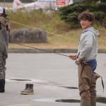 Middle schoolers practice fly casting in the parking lot of the Donald E. Gilman Kenai River Center in Soldotna, Alaska, during a kids camp put on by Trout Unlimited on Wednesday, May 24, 2023. (Jake Dye/Peninsula Clarion)