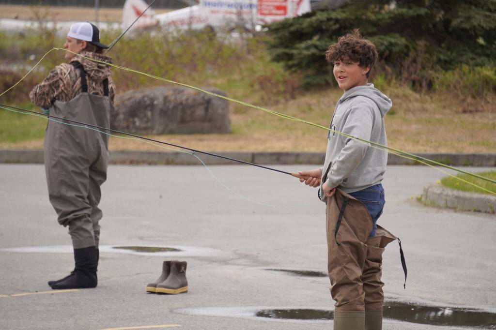 Middle schoolers practice fly casting in the parking lot of the Donald E. Gilman Kenai River Center in Soldotna, Alaska, during a kids camp put on by Trout Unlimited on Wednesday, May 24, 2023. (Jake Dye/Peninsula Clarion)