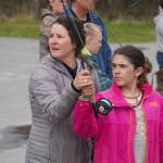 Alexa Millward helps Aviana Stroh with her fly cast during a kids camp put on by Trout Unlimited on Wednesday, May 24, 2023, at the Donald E. Gilman Kenai River Center in Soldotna, Alaska. (Jake Dye/Peninsula Clarion)