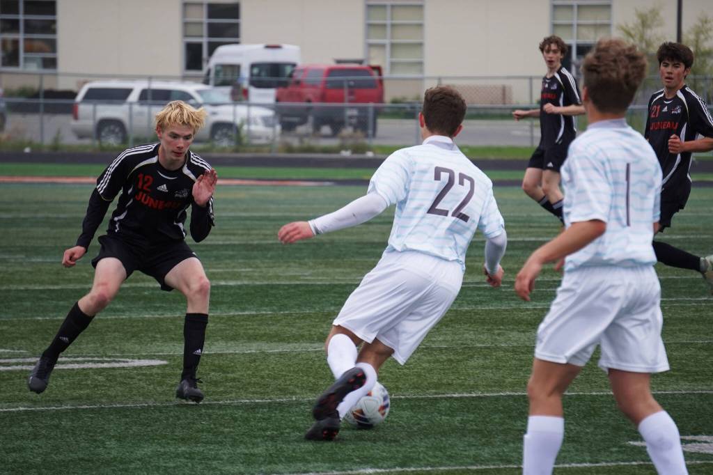 Juneau-Douglas Will Robinson moves to attack the ball, under the control of Soldotnas Zachary Buckbee, during the Division II Soccer State Championship on Saturday, May 27, 2023, at West Anchorage High School in Anchorage, Alaska. (Jake Dye/Peninsula Clarion)