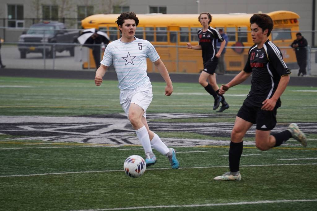 Soldotnas Gehret Medcoff and Juneau-Douglas Gabriel Cheng race for the ball during the Division II Soccer State Championship on Saturday, May 27, 2023, at West Anchorage High School in Anchorage, Alaska. (Jake Dye/Peninsula Clarion)