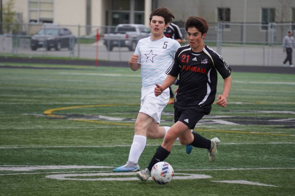 Soldotnas Gehret Medcoff and Juneau-Douglas Gabriel Cheng race for the ball during the Division II Soccer State Championship on Saturday, May 27, 2023, at West Anchorage High School in Anchorage, Alaska. (Jake Dye/Peninsula Clarion)