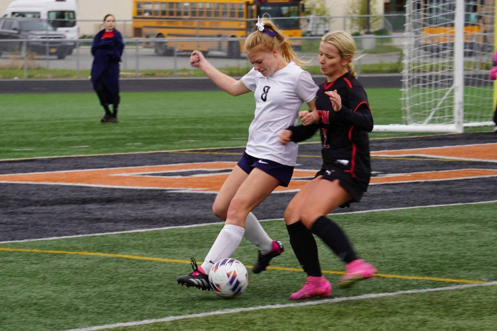 Soldotnas Keely Sundberg battles for the ball with Kenai Centrals Kate Wisnewski during the Division II Soccer State Championship on Saturday, May 27, 2023, at West Anchorage High School in Anchorage, Alaska. (Jake Dye/Peninsula Clarion)
