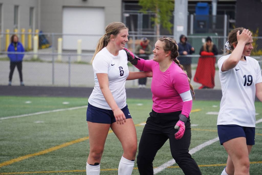 Soldotnas Alexandra Lee and Sunny Miller celebrate after the end of the fourth half of overtime during the Division II Soccer State Championship on Saturday, May 27, 2023, at West Anchorage High School in Anchorage, Alaska. (Jake Dye/Peninsula Clarion)