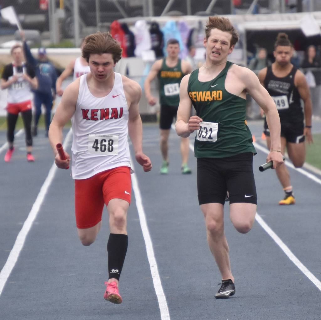 Kenai Centrals Reagan Graves and Sewards Emerson Cross battle in the Division II 400-meter relay Saturday, May 27, 2023, at the state track and field meet at Palmer High School in Palmer, Alaska. (Photo by Jeff Helminiak/Peninsula Clarion)