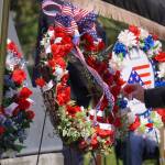 Poppies are affixed to wreaths during a Memorial Day ceremony on Monday, May 29, 2023, at Leif Hanson Memorial Park in Kenai, Alaska. (Jake Dye/Peninsula Clarion)