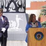 American Legion Post 20 Past Cmdr. David Segura stands as Tanya Lautaret speaks on behalf of Sen. Lisa Murkowski during a Memorial Day ceremony on Monday, May 29, 2023, at Leif Hanson Memorial Park in Kenai, Alaska. (Jake Dye/Peninsula Clarion)