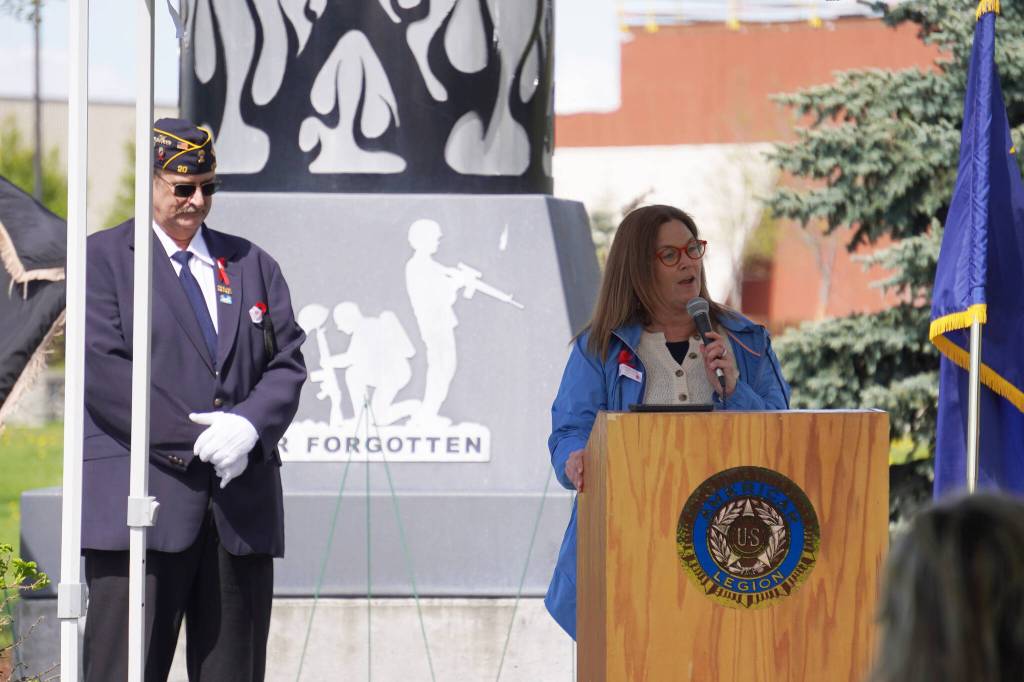 American Legion Post 20 Past Cmdr. David Segura stands as Tanya Lautaret speaks on behalf of Sen. Lisa Murkowski during a Memorial Day ceremony on Monday, May 29, 2023, at Leif Hanson Memorial Park in Kenai, Alaska. (Jake Dye/Peninsula Clarion)