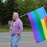 David Brighton holds a flag designating the end of the Soldotna Pride in the Park march group on Saturday, June 3, 2023 in Soldotna, Alaska. (Ashlyn OHara/Peninsula Clarion)
