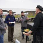 Judges Terry Eubank, Peter Micciche and Tyler Best sample a salmon dish prepared by chef Lastan Williams of The Catch at Return of the Reds on Saturday, June 3, 2023, at the Kenai City Dock in Kenai, Alaska. (Jake Dye/Peninsula Clarion)