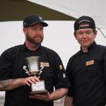 Kenai Peninsula Food Bank head chef Stephen Lamm and sous chef Christopher Smith stand with their trophy for winning the Return of the Reds Best Salmon Recipe competition on Saturday, June 3, 2023, at the Kenai City Dock in Kenai, Alaska. (Jake Dye/Peninsula Clarion)