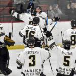 The Kenai River Brown Bears mob Ryan Finch after he scored the game-winning goal in overtime against the Janesville (Wisconsin) Jets on Saturday, Feb. 25, 2023, at the Soldotna Regional Sports Complex in Soldotna, Alaska. (Photo by Jeff Helminiak/Peninsula Clarion)