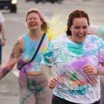 Participants are covered with colored powder during a color run held as part of during the Levitt AMP Soldotna Music Series on Wednesday, June 7, 2023, along the Sterling Highway in Soldotna, Alaska. (Jake Dye/Peninsula Clarion)
