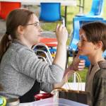 Children receive free face-painting during the Kenai River Festival on Friday, June 9, 2023, at Soldotna Creek Park in Soldotna, Alaska. (Jake Dye/Peninsula Clarion)