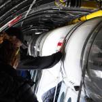 Attendees move down a passageway inside a large plane displayed at the Kenai Peninsula Air Fair on Saturday, June 10, 2023, at the Kenai Municipal Airport in Kenai, Alaska. (Jake Dye/Peninsula Clarion)