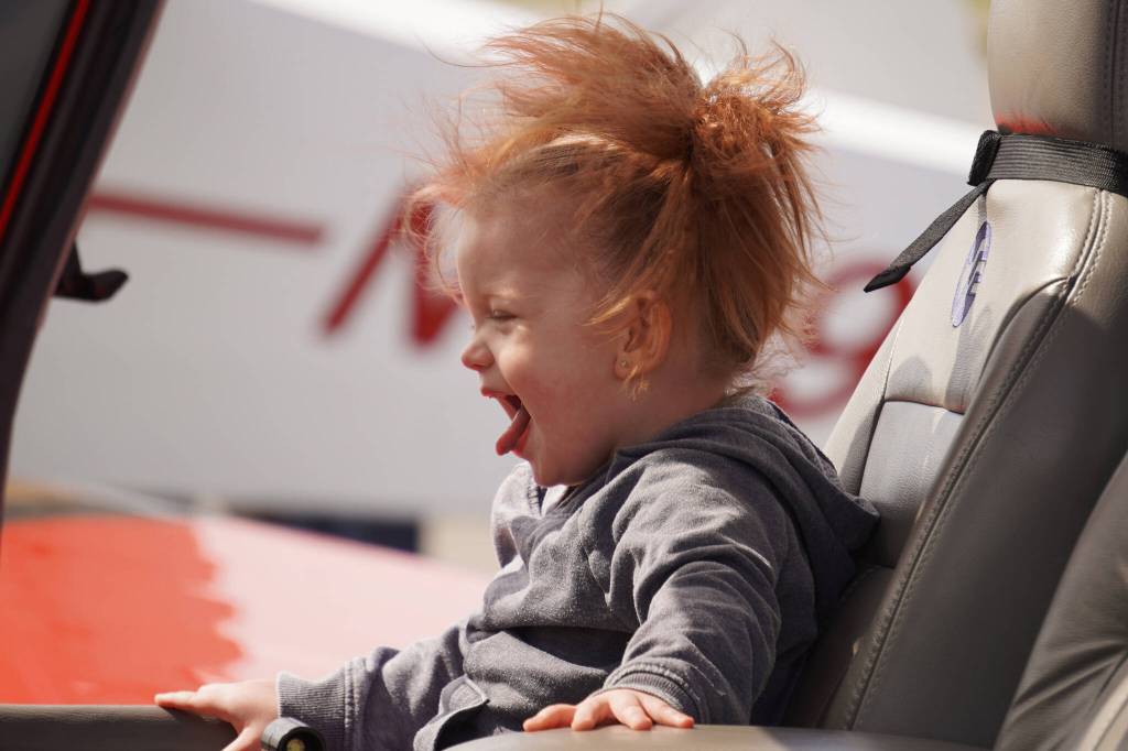 A child sits inside a plane displayed at the Kenai Peninsula Air Fair on Saturday, June 10, 2023, at the Kenai Municipal Airport in Kenai, Alaska. (Jake Dye/Peninsula Clarion)