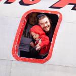 Attendees look out from a window inside a large plane displayed at the Kenai Peninsula Air Fair on Saturday, June 10, 2023, at the Kenai Municipal Airport in Kenai, Alaska. (Jake Dye/Peninsula Clarion)