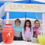 Sweeter than Sour Lemonade slings tasty drinks while sheltering from the rain in front of The Brunch Bar in Kenai, Alaska, on Lemonade Day, Saturday, June 10, 2023. (Jake Dye/Peninsula Clarion)