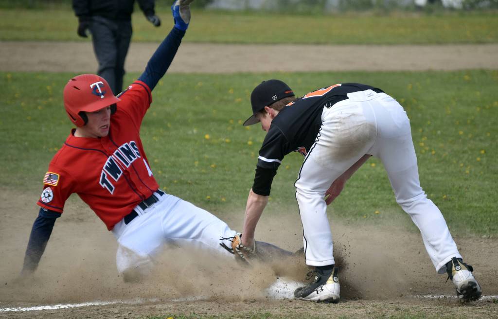 Derrick Jones of the American Legion Twins is tagged out by West third baseman Jack Boots on a steal attempt Sunday, June 11, 2023, at the Soldotna Little League fields in Soldotna, Alaska. (Photo by Jeff Helminiak/Peninsula Clarion)