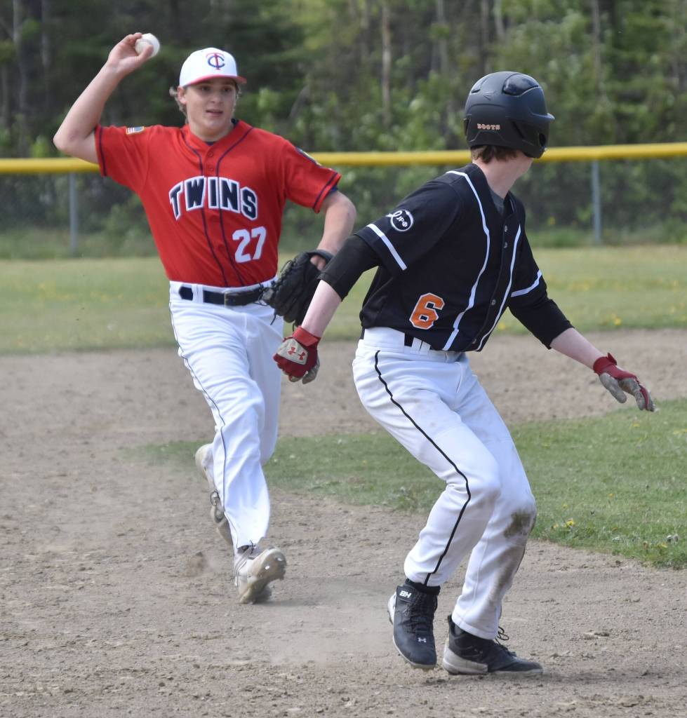 American Legion Twins second baseman Trenton Ohnemus chases Wests Jack Boots in a rundown Sunday, June 11, 2023, at the Soldotna Little League fields in Soldotna, Alaska. (Photo by Jeff Helminiak/Peninsula Clarion)