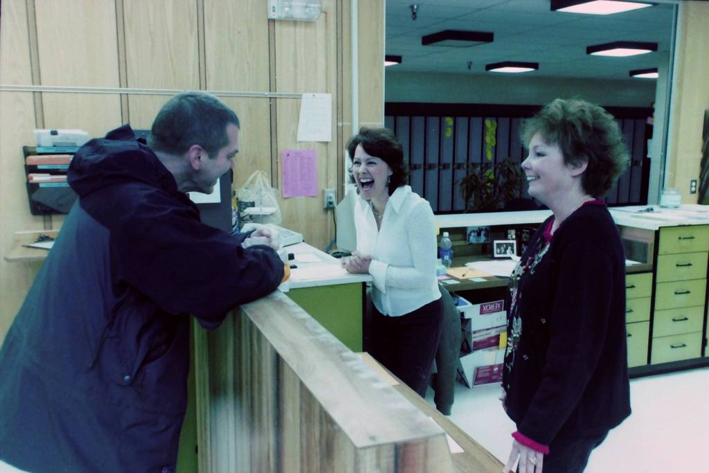 Robert Summer laughs in the office with Carole Nolden at Kenai Middle School in Kenai, Alaska, in November 2004. (M. Scott Moon/Peninsula Clarion file)