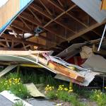 Red caution tape hangs off of building materials at the site of the former ZipMart on Wednesday, June 14, 2023, in Sterling, Alaska. (Ashlyn OHara/Peninsula Clarion)
