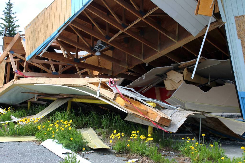Red caution tape hangs off of building materials at the site of the former ZipMart on Wednesday, June 14, 2023, in Sterling, Alaska. (Ashlyn OHara/Peninsula Clarion)