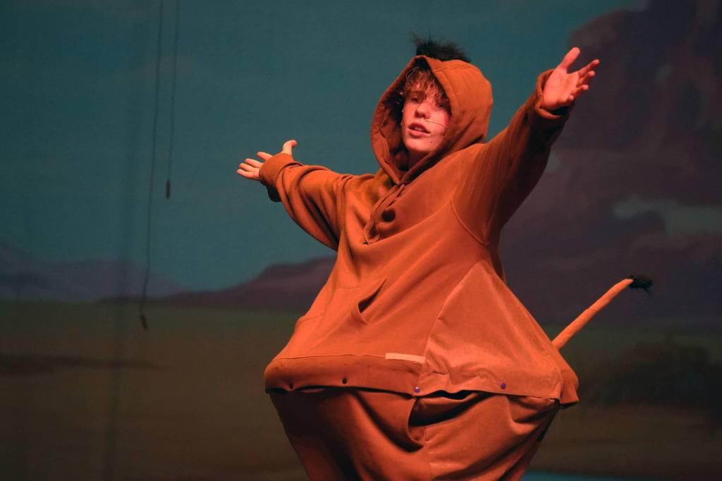Gage Sturman portrays Pumbaa during a rehearsal of The Lion King Jr. in the Renee C. Henderson Auditorium in Kenai, Alaska, on Tuesday, June 6, 2023. (Jake Dye/Peninsula Clarion)