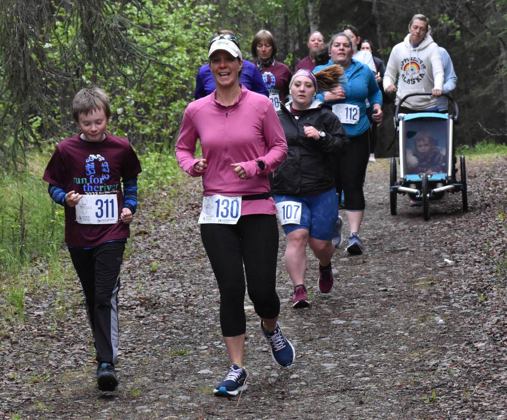 Conner Morris and Kylie Morris lead a pack of runners at the Run for the River on Saturday, June 10, 2023, in Soldotna, Alaska. (Photo by Jeff Helminiak/Peninsula Clarion)