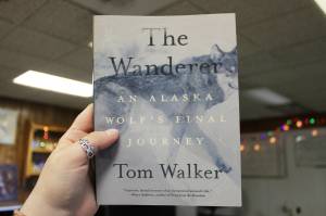 A copy of Tom Walkers The Wanderer: An Alaska Wolfs Final Journey is held in The Peninsula Clarion building on Thursday, June 15, 2023 in Kenai, Alaska. (Ashlyn OHara/Peninsula Clarion)
