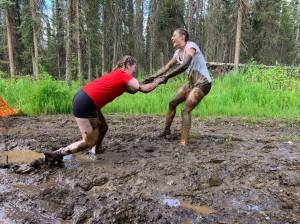 Muddy runners move down the Tsalteshi Trails Porcupine Loop in Soldotna, Alaska, as they participate in the KDLL Mud Run on Friday, June 16, 2023. (Photo provided by KDLL 91.9 FM)