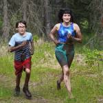 Muddy runners move down the Tsalteshi Trails Porcupine Loop in Soldotna, Alaska, as they participate in the KDLL Mud Run on Friday, June 16, 2023. (Jake Dye/Peninsula Clarion)