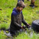 A contestant sits in the mud during the KDLL Mud Run at Tsalteshi Trails in Soldotna, Alaska, on Friday, June 16, 2023. (Jake Dye/Peninsula Clarion)