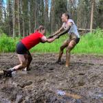 Muddy runners move down the Tsalteshi Trails Porcupine Loop in Soldotna, Alaska, as they participate in the KDLL Mud Run on Friday, June 16, 2023. (Photo provided by KDLL 91.9 FM)