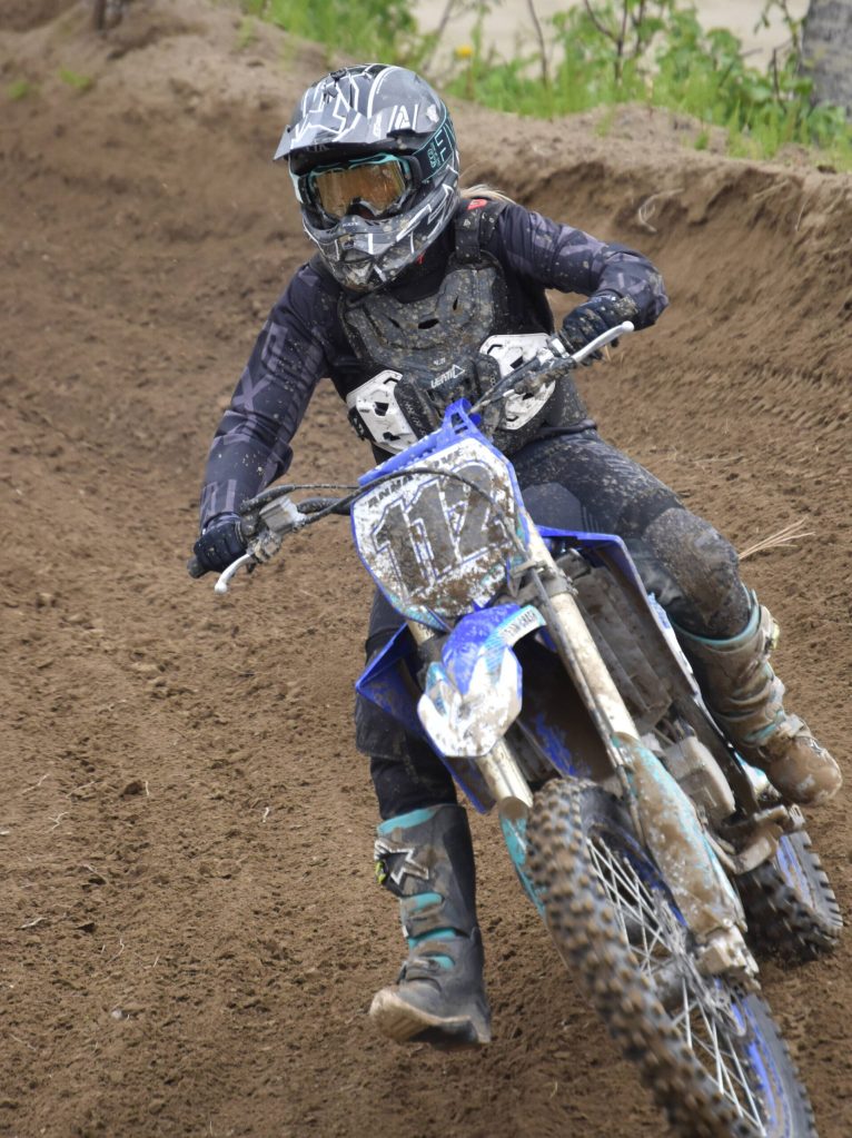 Anna Love rounds a corner at Alaska State Motocross Race 3 on Saturday, June 17, 2023, at Twin City Raceway in Kenai, Alaska. (Photo by Jeff Helminiak/Peninsula Clarion)