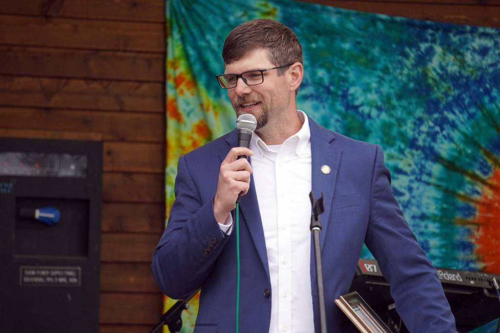 Sen. Jesse Bjorkman awards members of the Kenai Central High School cheerleading team with a legislative citation ahead of the start of the Soldotna Music Series performance on Wednesday, June 21, 2023, at Soldotna Creek Park in Soldotna, Alaska. (Jake Dye/Peninsula Clarion)