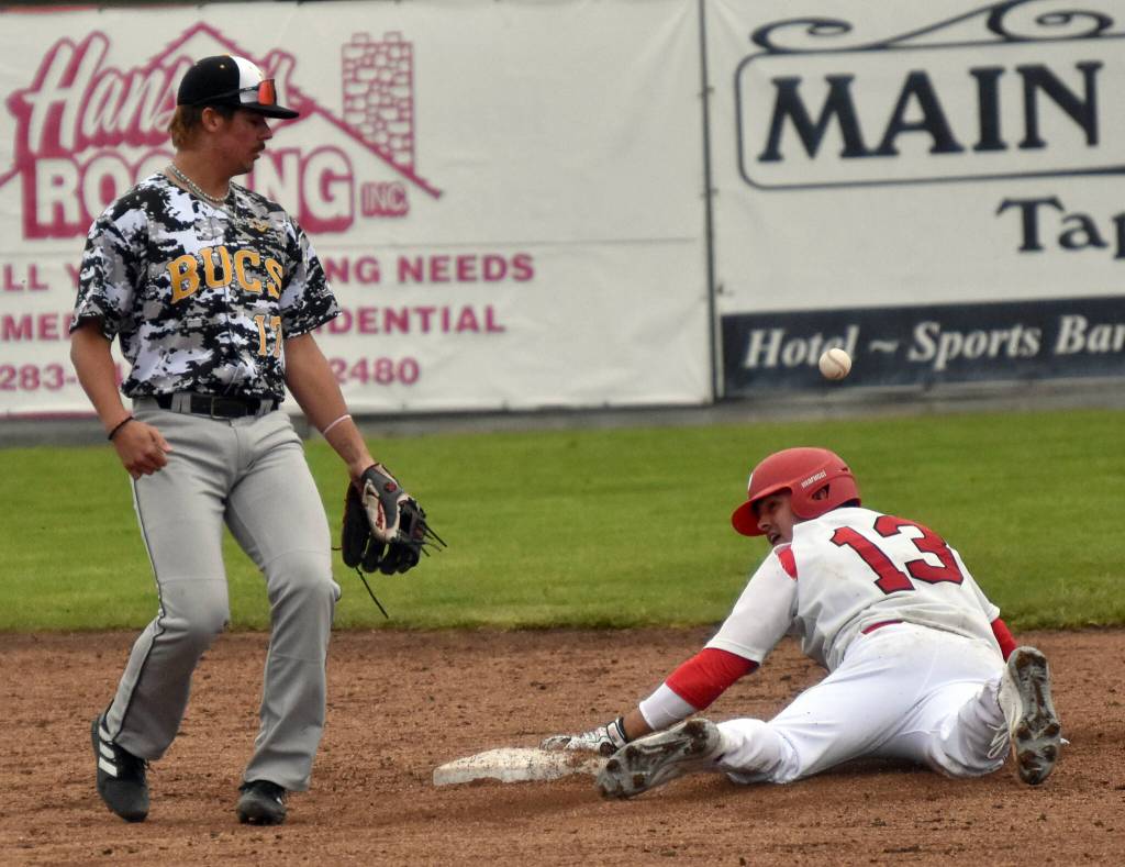 Peninsula Oilers Leighton Helfrick slides in front of Bucs shortsthop Logan Hokuf on Wednesday, June 21, 2023, at Coral Seymour Memorial Park in Kenai. Helfricks effort did not result in a stolen base because the base was already his due to a walk. (Photo by Jeff Helminiak/Peninsula Clarion)