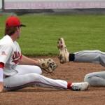 Anchorage Bucs Myles Smith slides past the tag of Peninsula Oilers shortstop Michael Elko on Wednesday, June 21, 2023, at Coral Seymour Memorial Park in Kenai, Alaska. (Photo by Jeff Helminiak/Peninsula Clarion)