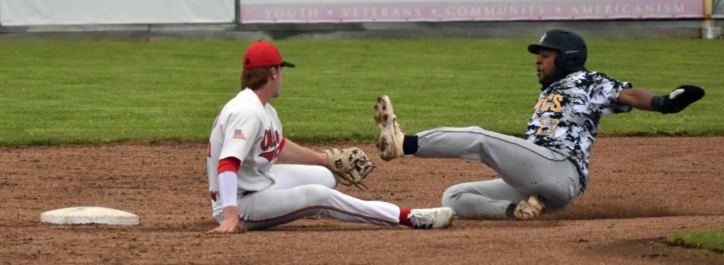 Anchorage Bucs Myles Smith slides past the tag of Peninsula Oilers shortstop Michael Elko on Wednesday, June 21, 2023, at Coral Seymour Memorial Park in Kenai, Alaska. (Photo by Jeff Helminiak/Peninsula Clarion)