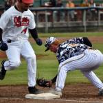 Peninsula Oilers Josiah Chavez is out at first after a sacrfice bunt as Anchorage Bucs second baseman Alex Pendergast makes the catch Friday, June 23, 2023, at Coral Seymour Memorial Park in Kenai, Alaska. (Photo by Jeff Helminiak/Peninsula Clarion)