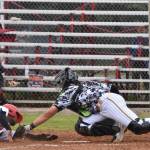 Peninsula Oilers Drewbie Pinkston scores on a sacrifice fly past Anchorage Bucs catcher Trenton Burkhalter to tie the game at 4 in the eighth Friday, June 23, 2023, at Coral Seymour Memorial Park in Kenai, Alaska. (Photo by Jeff Helminiak/Peninsula Clarion)