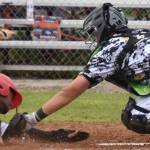 Peninsula Oilers' Drewbie Pinkston scores on a sacrifice fly past Anchorage Bucs catcher Trenton Burkhalter to tie the game at 4 in the eighth Friday, June 23, 2023, at Coral Seymour Memorial Park in Kenai, Alaska. (Photo by Jeff Helminiak/Peninsula Clarion)
