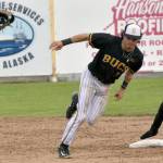 Anchorage Bucs shortstop Curtis Hebert loses his glove in trying to tag out Peninsula Oilers Owen McElfatrick on a stolen base Saturday, June 24, 2023, at Coral Seymour Memorial Park in Kenai, Alaska. (Photo by Jeff Helminiak/Peninsula Clarion)