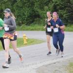 Alex Whitworth and Homers Megan Hahn lead a pack of runners in the Homer Spit Run 10K at Ben Walters Lane on Saturday, June 24, 2023, in Homer, Alaska. (Delcenia Cosman/Homer News)