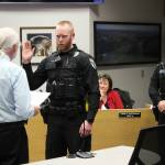 From left, Soldotna Mayor Paul Whitney swears in Soldotna Police Officer Bryan Hahn while Soldotna Police Chief Gene Meek looks on during a Soldotna City Council meeting on Wednesday, June 28, 2023 in Soldotna, Alaska. (Ashlyn O'Hara/Peninsula Clarion)