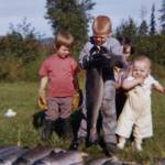 The Fenger children  (left to right) Heidi, Eric and Peter  delight in a bounty of silver salmon gathered by setnet below their home in August 1962. (Photo courtesy of the Fenger Family Collection)