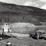 Photos courtesy of the Fenger Family Collection
John Fenger took this photo when he traveled to Alaska in 1954 with Drs. Helen and Robert Whaley. Here, they are preparing to take their vehicles across the Stuart River in the Yukon Territory. Robert Whaley is standing by his car, while Helen Whaley is standing aboard the ferry.