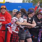 The Kenai Central High School football team smiles as the Fourth of July Parade moves down the Kenai Spur Highway in Kenai, Alaska on Tuesday, July 4, 2023. (Jake Dye/Peninsula Clarion)