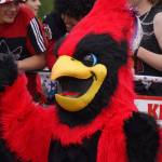 Tuffy the Kardinal waves as the Fourth of July Parade moves down the Kenai Spur Highway in Kenai, Alaska on Tuesday, July 4, 2023. (Jake Dye/Peninsula Clarion)